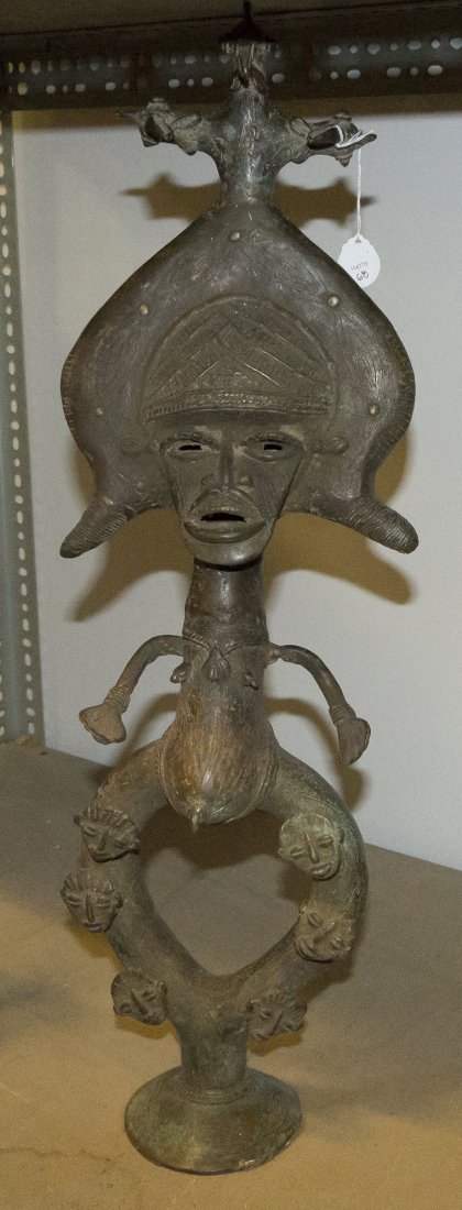A Cameroon Bronze Reliquary, Height 25 3/4 inches: A Cameroon Bronze Reliquary, in the form of a standing woman with a broad flat face and a bird form headdress. Height 25 3/4 inches Property from the Collection of Gerald F. Glaeve, Mount Horeb, Wisco