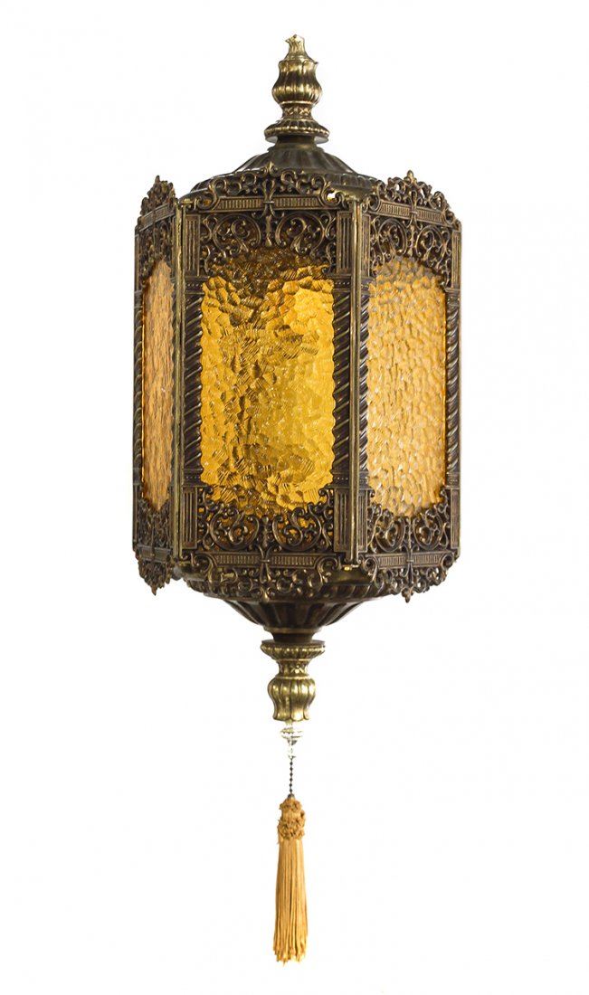 A Victorian Style Amber Glass and Brass Hanging Lamp,: A Victorian Style Amber Glass and Brass Hanging Lamp, of hexagonal form, each panel worked to show C- and S- scrolls and enclosing a glass panel. Height 24 inches.