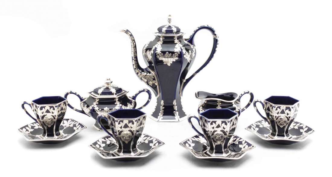A Silver Overlaid and Cobalt Painted Porcelain Coffee: A Silver Overlaid and Cobalt Painted Porcelain Coffee Service, comprising a coffee pot, a creamer, a sugar, 12 demitasse cups and 12 saucers, the silver overlay by Black Starr & Frost. Height of coffe