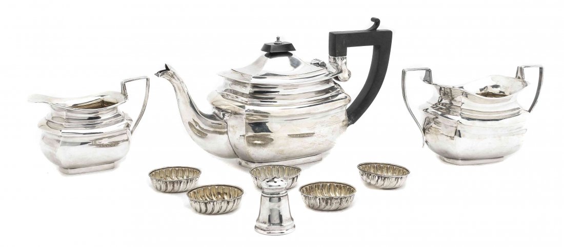 An Edwardian Silver Three-Piece Tea Service, S.: An Edwardian Silver Three-Piece Tea Service, S. Blanckensee and Sons, Birmingham, 1910, comprising a teapot, creamer and sugar bowl, together with salts and a caster. Width of largest 9 1/2 inches.