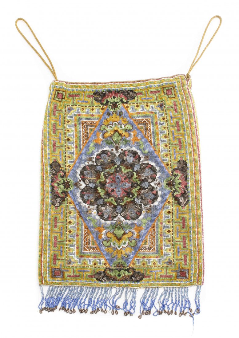 A Beaded Evening Bag, Height without fringe 10 1/2: A Beaded Evening Bag, having glass beads in a geometric and floral pattern, with drawstrings at top and fringe and bottom. Height without fringe 10 1/2 inches x width 8 inches.