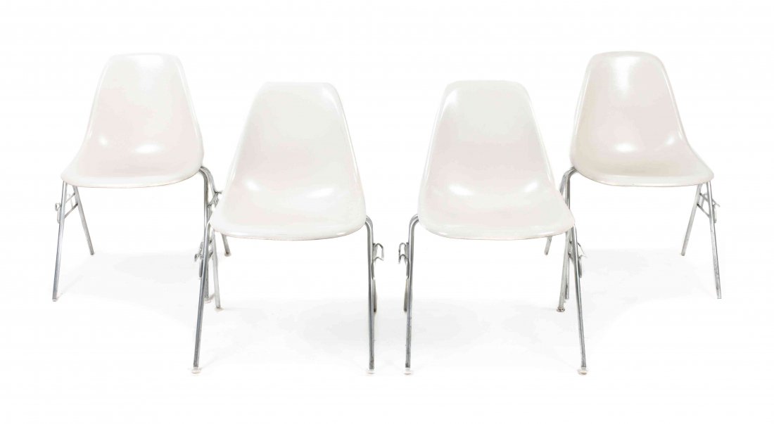 A Group of Four Charles and Ray Eames Chairs, Height 31: A Group of Four Charles and Ray Eames Chairs, each having a molded white fiberglass seat and raised on tubular legs. Height 31 inches. Property from the Collection of the Milwaukee Public Library, Mil