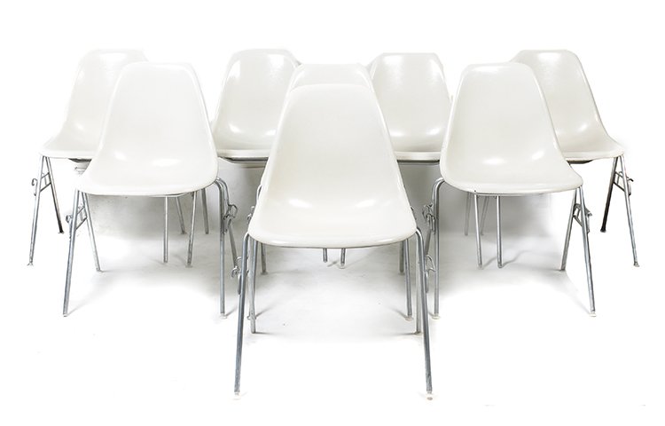 A Group of Eight Charles and Ray Eames Chairs, Height: A Group of Eight Charles and Ray Eames Chairs, each having a molded white fiberglass seat and raised on tubular legs. Height 31 inches. Property from the Collection of the Milwaukee Public Library, Mi
