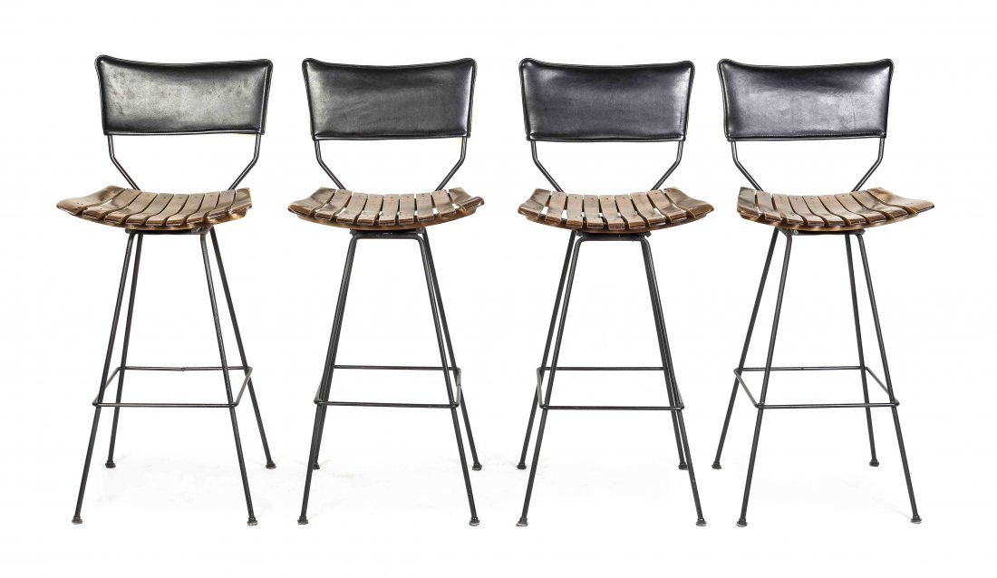 Four Contemporary Teak Barstools, Height 41 1/2 inches.: Four Contemporary Teak Barstools, mid-century, each having a leather upholstered back and slatted seat, raised on patinated metal legs joined by a square stretcher. Height 41 1/2 inches.