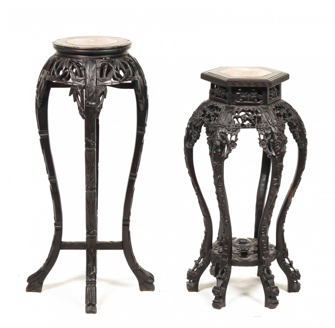 Two Chinese Carved Hardwood Pedestals, Height of: Two Chinese Carved Hardwood Pedestals, one having a circular top, the other hexagonal, each with captured marble above pierce carved aprons and raised on shaped legs. Height of tallest 35 1/4 inches.