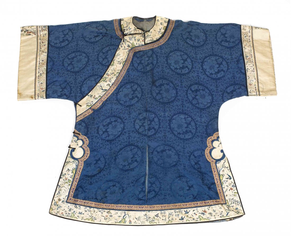 A Chinese Lady's Blouse, Length 45 inches.: A Chinese Lady's Blouse, of a deep blue silk with a floral medallion pattern, with embroidered silk borders. Length 45 inches. Property from the Collection of Lisa Robbins, Milwaukee, Wisconsin