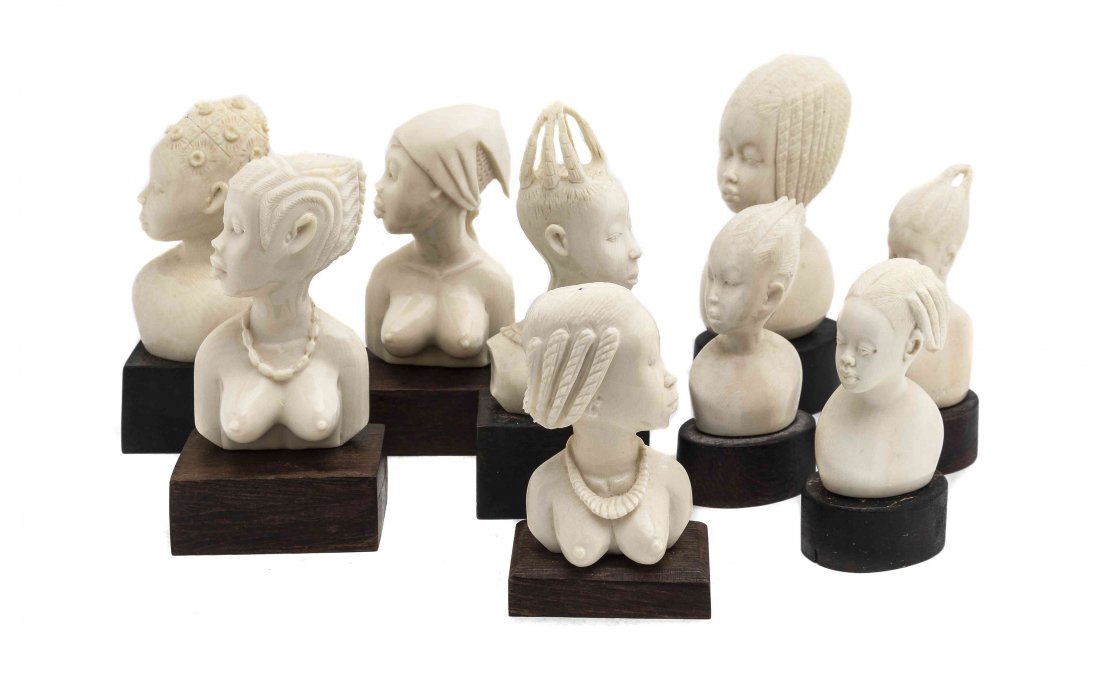 A Collection of Nine African Carved Ivory Busts of: A Collection of Nine African Carved Ivory Busts of Females, each depicted with different hairstyles and mounted to a wood base, two inscribed 'Mana' and three inscribed 'Monkolo' at back. Height of ta