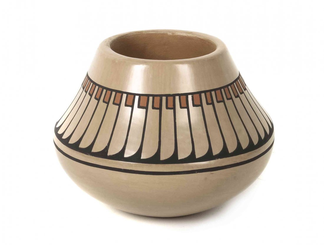 A Santa Clara Polychrome Stone Polished Jar, Height 5 x: A Santa Clara Polychrome Stone Polished Jar, buff clay with feather design around perimeter, signed Blue Corn, Santa Clara, Pueblo. Height 5 x diameter 5 1/4 inches. Property from the Estate of Betty 