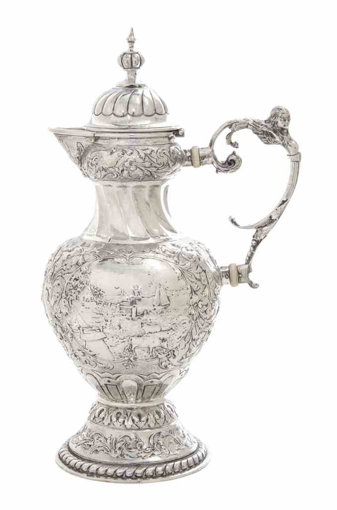 A Dutch Silver Coffee Pot, Maker's Mark MG, Late 19th: A Dutch Silver Coffee Pot, Maker's Mark MG, Late 19th Century, the vase form body chased with pastoral landscapes surrounded by dense scrolling foliage against a matted ground, the neck spirally flute