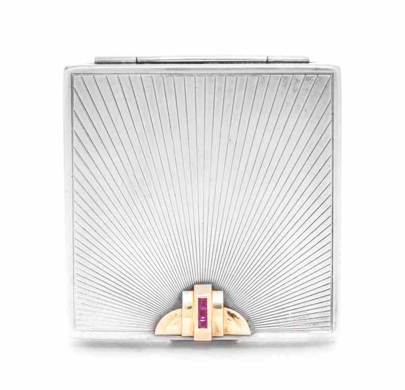 An American 14-Karat Gold, Silver and Ruby-Mounted: An American 14-Karat Gold, Silver and Ruby-Mounted Compact, Maker's Mark WAB, Circa 1930, rectangular, the cover engraved with a sunburst pattern and with gold and ruby deco mount near thumbpiece, int