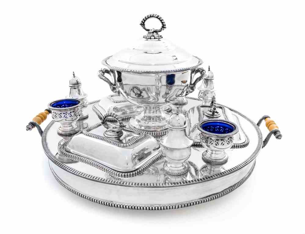 A Silver-Plate Supper Service, Mid 20th Century, Length: A Silver-Plate Supper Service, Mid 20th Century, the rotating circular base fitted with a circular soup tureen, three rectangular entree dishes, three salts with blue glass liners and three casters, a