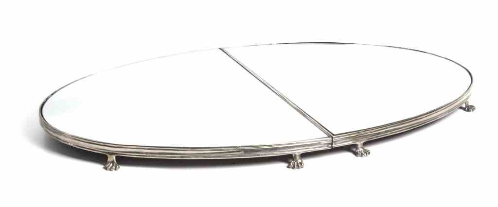 A Silver-Plate Mirrored Table Plateau, Length 41: A Silver-Plate Mirrored Table Plateau, oval form in two parts, with reeded edge set on paw feet. Length 41 inches. Property from the Collection of Paul Mavros and David Valkema, Long Beach, Indiana