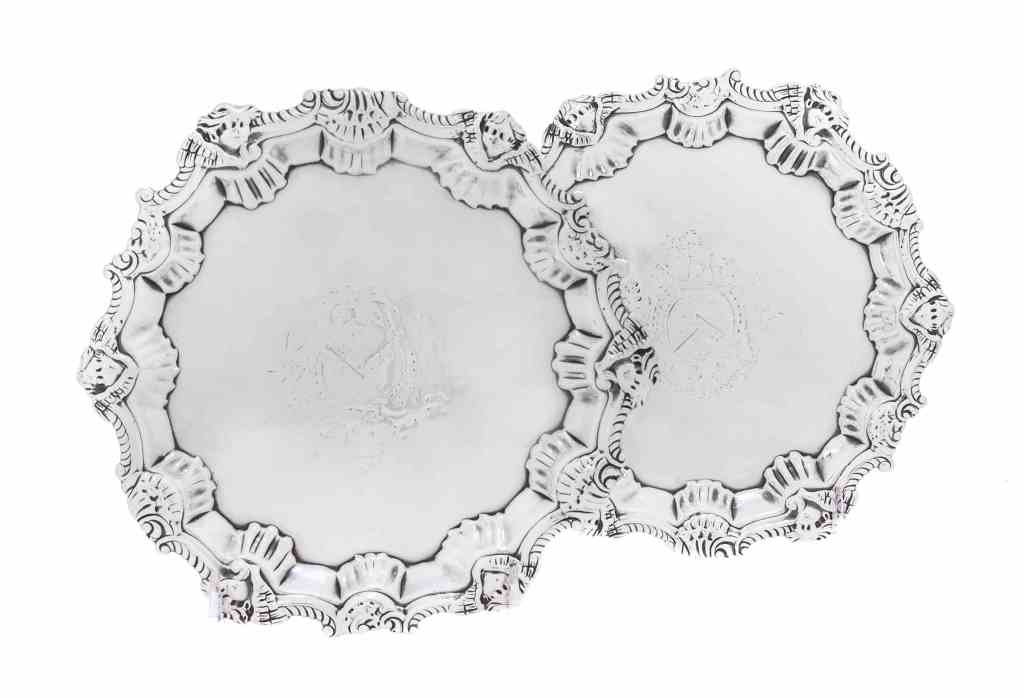 A Pair of George II Silver Salvers, Hugh Mills, London,: A Pair of George II Silver Salvers, Hugh Mills, London, 1750, shaped circular, the gadroon border with putto heads alternating with shells at intervals, the centers engraved with contemporary arms wit