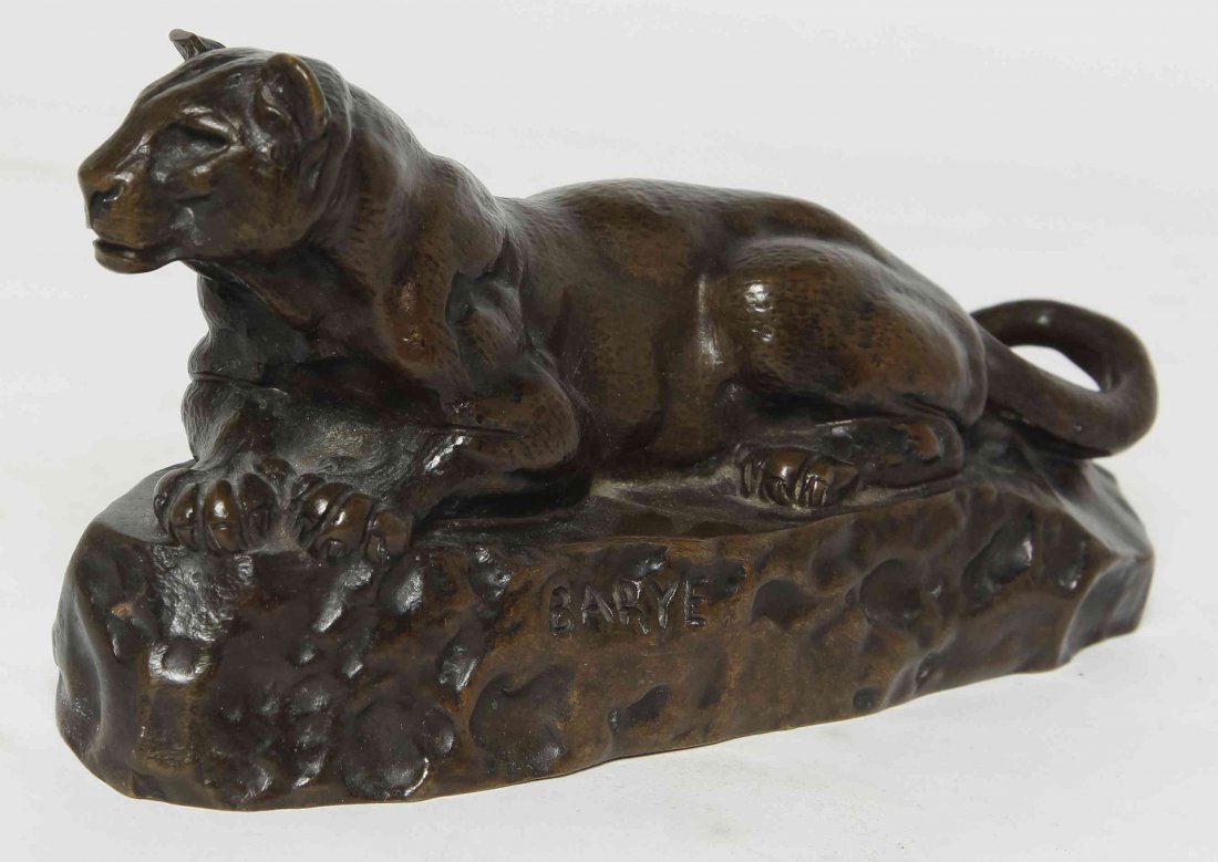 A Cast Bronze Mountain Lion, after Antoine-Louis Barye,: A Cast Bronze Mountain Lion, after Antoine-Louis Barye, depicted resting on a naturalistic base, signed Barye to base. Height 3 1/2 inches. Property from the Estate of Louis M. and Linda M. Byron, Tuc