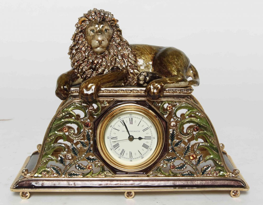 A Jay Strongwater Desk Clock, Height 8 inches.: A Jay Strongwater Desk Clock, having a lion form figural mount over the pierced case, centered with the circular clock face having Roman numeral hours. Height 8 inches. Property from the Estate of Lou