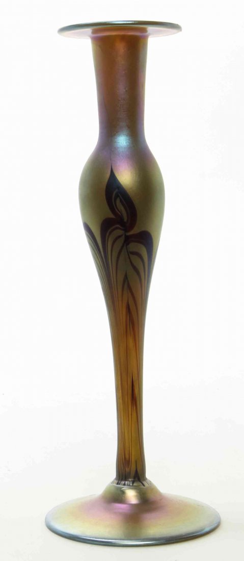 A Studio Glass Candlestick, Height 11 inches.: A Studio Glass Candlestick, of baluster form, with pulled decoration, having spurious Tiffany signature. Height 11 inches. Property from the Collection of a Lady, Oak Brook, Illinois