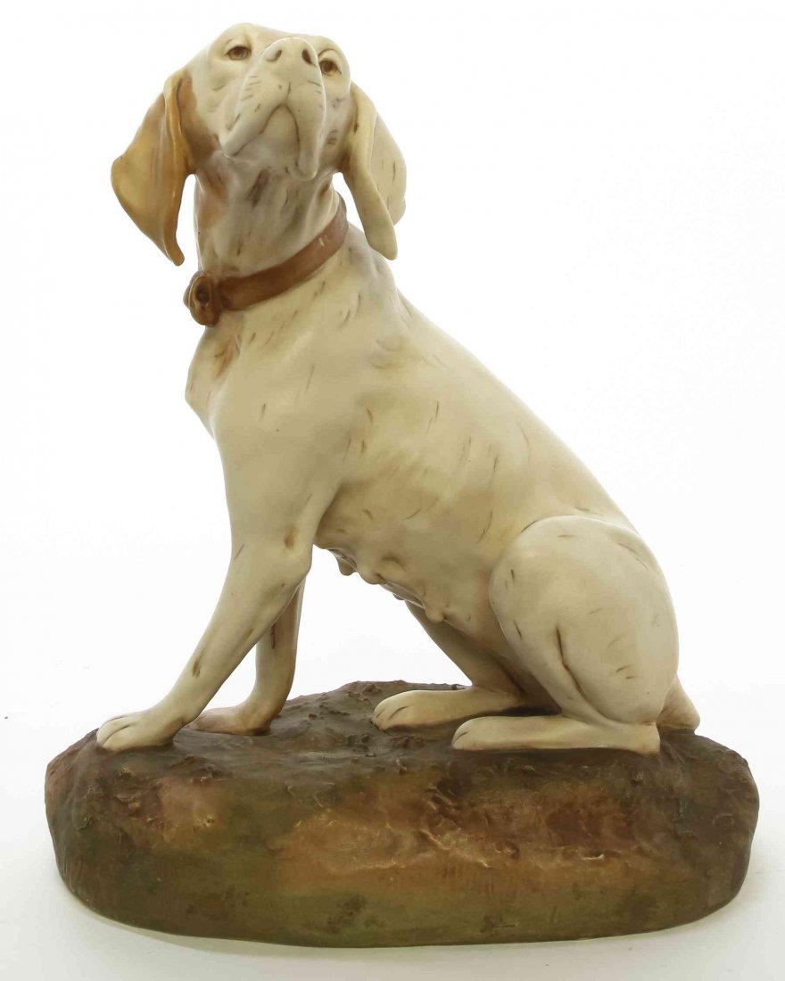 A Royal Dux Canine Figure, Height 10 3/8 inches.: A Royal Dux Canine Figure, depicting a seated hound, impressed 1565. Height 10 3/8 inches. Property from the Collection of a Lady, Oak Brook, Illinois