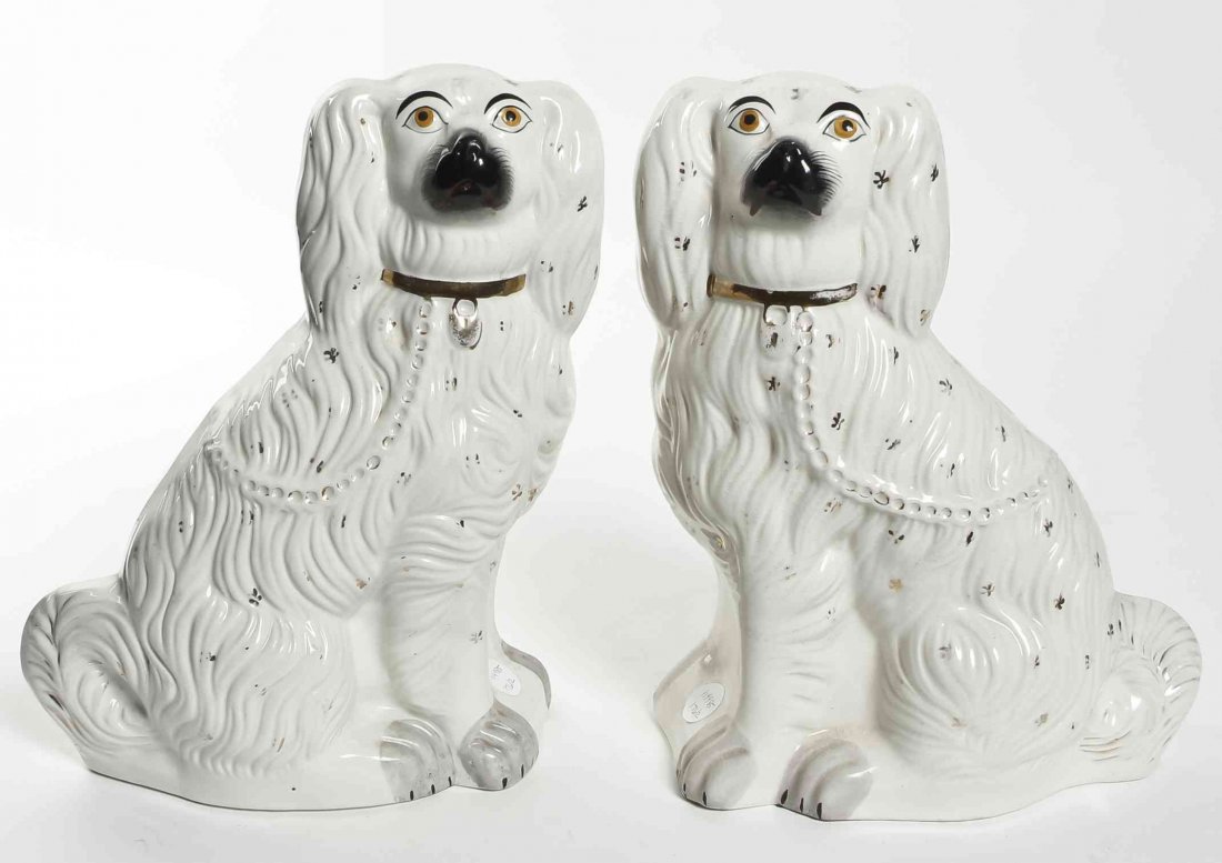 A Pair of Staffordshire Spaniels, Height 13 inches.: A Pair of Staffordshire Spaniels, each depicted in a seated pose with a gilt locket. Height 13 inches. Property from the Collection of Dan Johnson, Chicago, Illinois