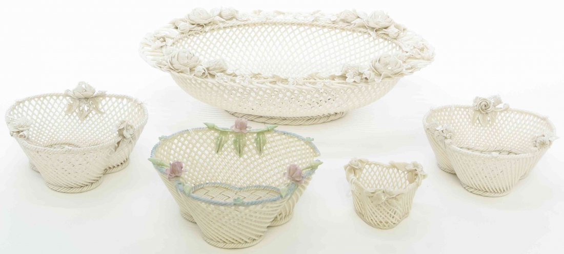 Four Belleek Baskets, Width of widest 12 1/8 inches.: Four Belleek Baskets, 1863-1920, comprising one oval, two of trefoil form and one triangular, together with a four-strand trefoil basket with tinted flowers, having various Belleek pad marks to bases.