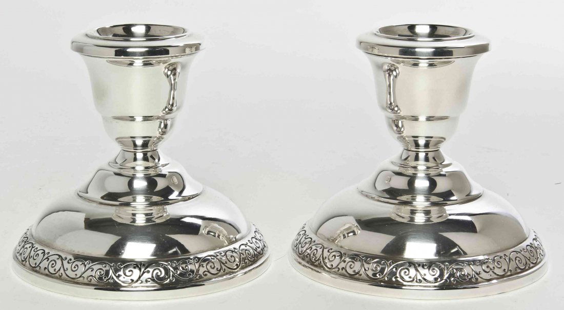 A Pair of American Silver Candlesticks, Wallace: A Pair of American Silver Candlesticks, Wallace Silversmiths, Wallingford, CT, raised on circular bases with scrolling decoration, weighted. Height 3 1/2 inches. Property from the Collection of John M