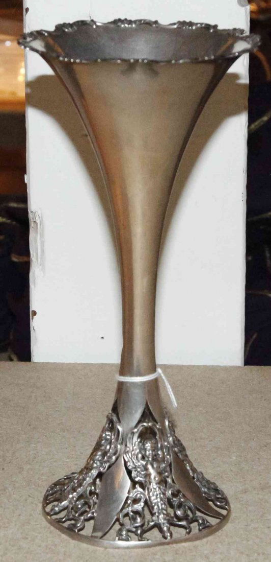 An American Silver Trumpet Vase, George W. Sheibler &: An American Silver Trumpet Vase, George W. Sheibler & Co., New York, Circa 1900, the openwork base cast with caryatid putto flanked by scrolling foliage, marked on underside; 8 ozt 6 dwt. Height 9 3/8