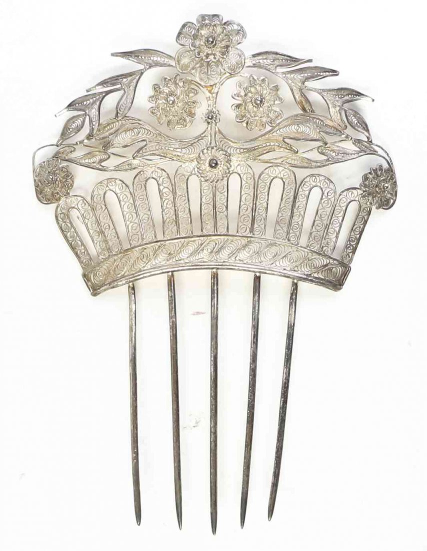 A Silver Filigree Large Hair Pin, Late 19th/Early 20th: A Silver Filigree Large Hair Pin, Late 19th/Early 20th Century, the top formed as a coronet with flowers and foliage. Length 4 7/8 inches. Property from the Collection of Gertrude Mandelstam Spear, Bo