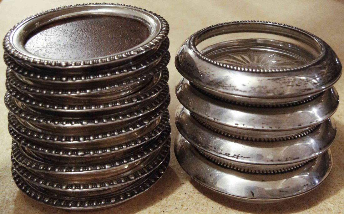 A Group of Fourteen American Silver-Mounted Coasters,: A Group of Fourteen American Silver-Mounted Coasters, 20th Century, four with beaded borders and glass bases, ten with gadrooned borders and wood centers, all marked STERLING. Diameter of largest 3 7/