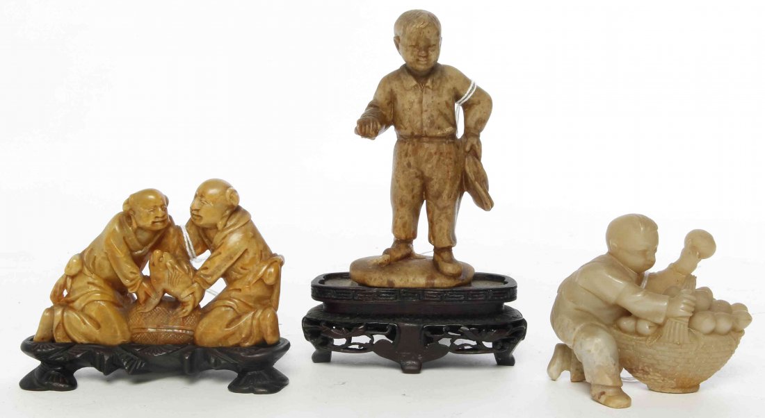 Three Carved Soapstone Figures, Height of first 3 5/8: Three Carved Soapstone Figures, the first depicting a boy with a basket of fruit, the second depicting a boy standing, and the third depicting men with fish. Height of first 3 5/8 inches.