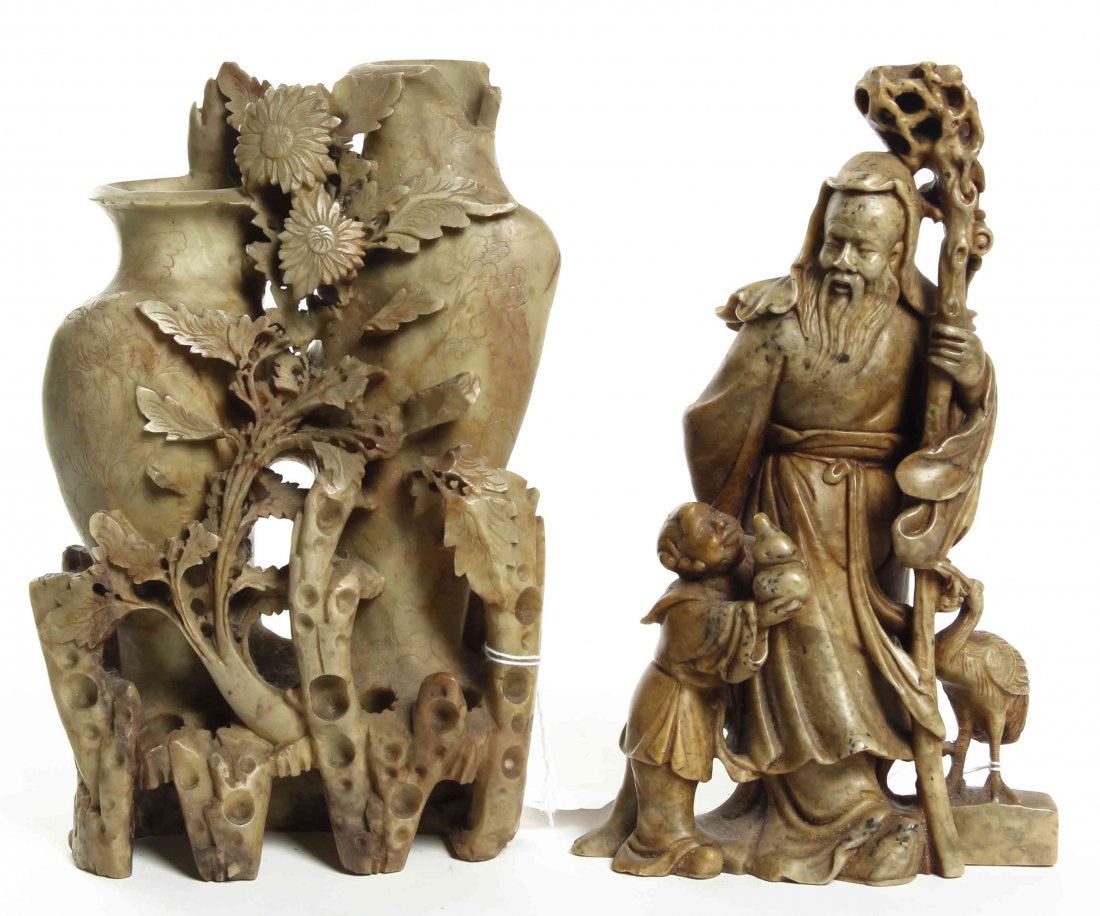 A Carved Soapstone Figure of Shoulao, Height of first 9: A Carved Soapstone Figure of Shoulao, the god depicted with a craggy staff and a figure bearing a double gourd, together with a soapstone double spill vase, each raised on a wood stand. Height of firs