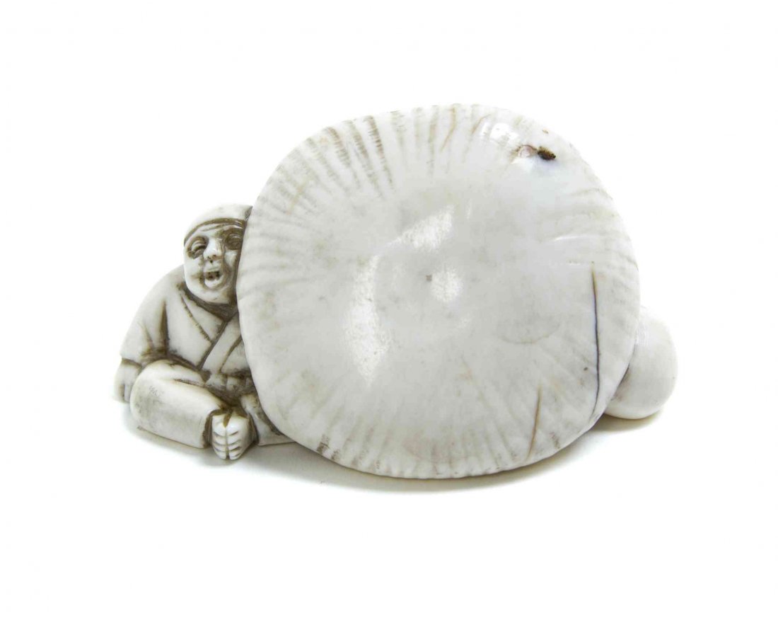 A Carved Ivory Figural Netsuke, Width 2 1/4 inches.: A Carved Ivory Figural Netsuke, depicting a seated man with an oversized mushroom, signed. Width 2 1/4 inches. Property from the Collection of Dr. J. Don Nelson, Fargo, North Dakota Provenance: Purcha