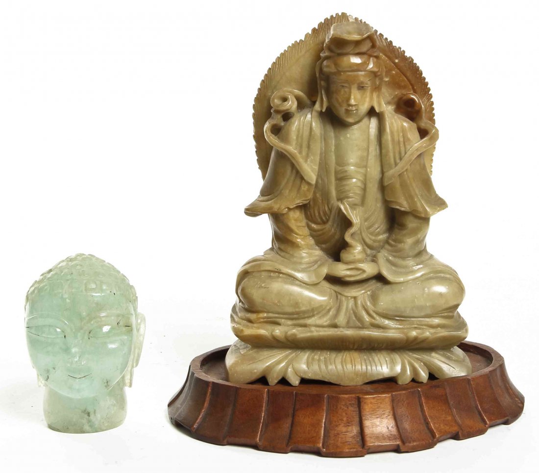 A Chinese Carved Soapstone Figure of Buddha, Height of: A Chinese Carved Soapstone Figure of Buddha, on a carved wood stand, together with a carved beryl head of Buddha. Height of first 6 1/2 inches. Property from the Estate of Benjamin and Louise Pritz, C