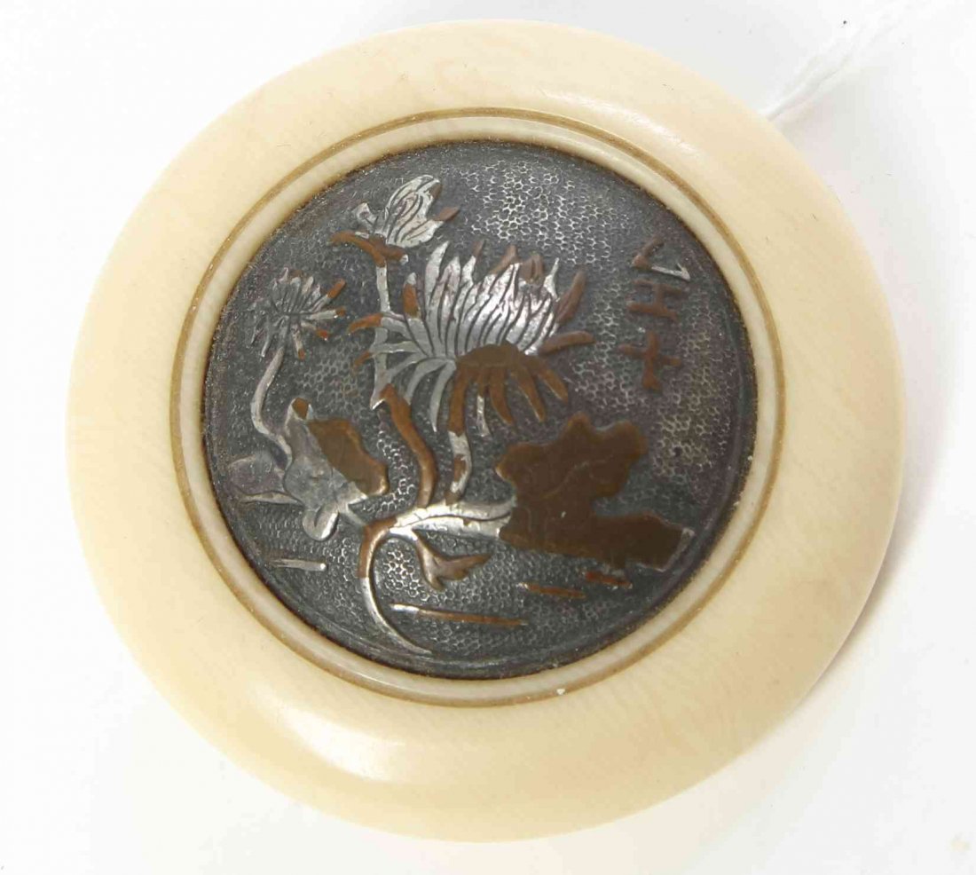 An Ivory and Metal Manju Netsuke, Diameter 2 1/8: An Ivory and Metal Manju Netsuke, of circular form. Diameter 2 1/8 inches.