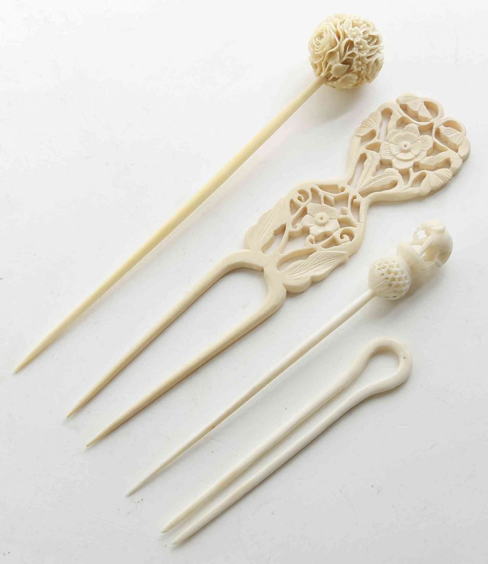 A Group of Four Ivory Hairpins, Length of longest 5 5/8: A Group of Four Ivory Hairpins, two with floral decoration, one having an elephant on stand, and the other without decoration. Length of longest 5 5/8 inches. Property from the Collection of Gertrude