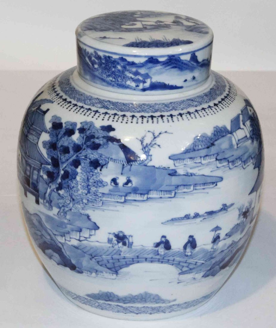A Blue and White Porcelain Covered Ginger Jar, Height: A Blue and White Porcelain Covered Ginger Jar, decorated with figures in a landscape with houses and a bridge, bearing apocryphal Kangxi mark to underside. Height 10 inches.