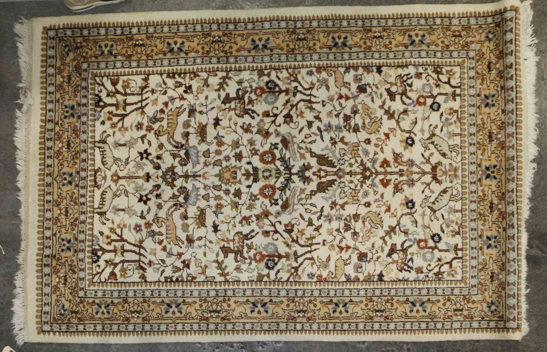 A Persian Wool Rug, 5 feet 10 inches x 4 feet.: A Persian Wool Rug, decorated with scrolling foliate and animal forms on an ivory field within triple borders. 5 feet 10 inches x 4 feet. Property from the Collection of Dan Johnson, Chicago, Illinois