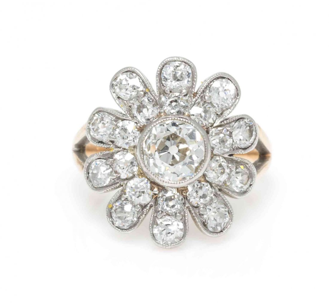 An Edwardian Platinum Topped Gold and Diamond Ring,: An Edwardian Platinum Topped Gold and Diamond Ring, containing one old European cut diamond weighing approximately 0.70 carat and 20 old mine cut diamonds weighing approximately 1.40 carats total. 2.8