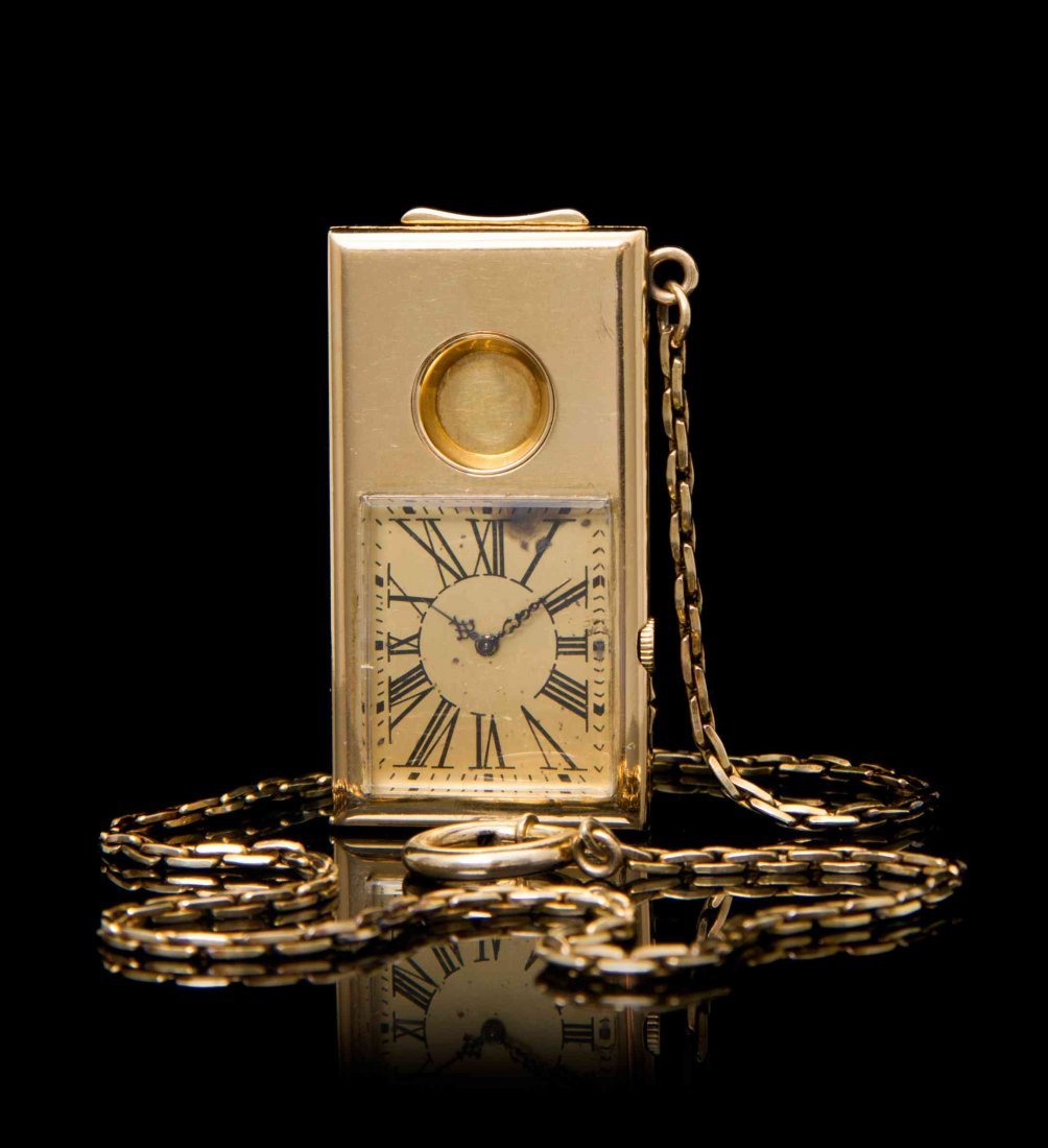An 18 Karat Yellow Gold Watch and Cigar Cutter, Circa: An 18 Karat Yellow Gold Watch and Cigar Cutter, Circa 1915, attributed to Tiffany & Co., gilt dial, Roman numerals, cathedral hands, manual wind mechanical movement, polished rectangular case with gui