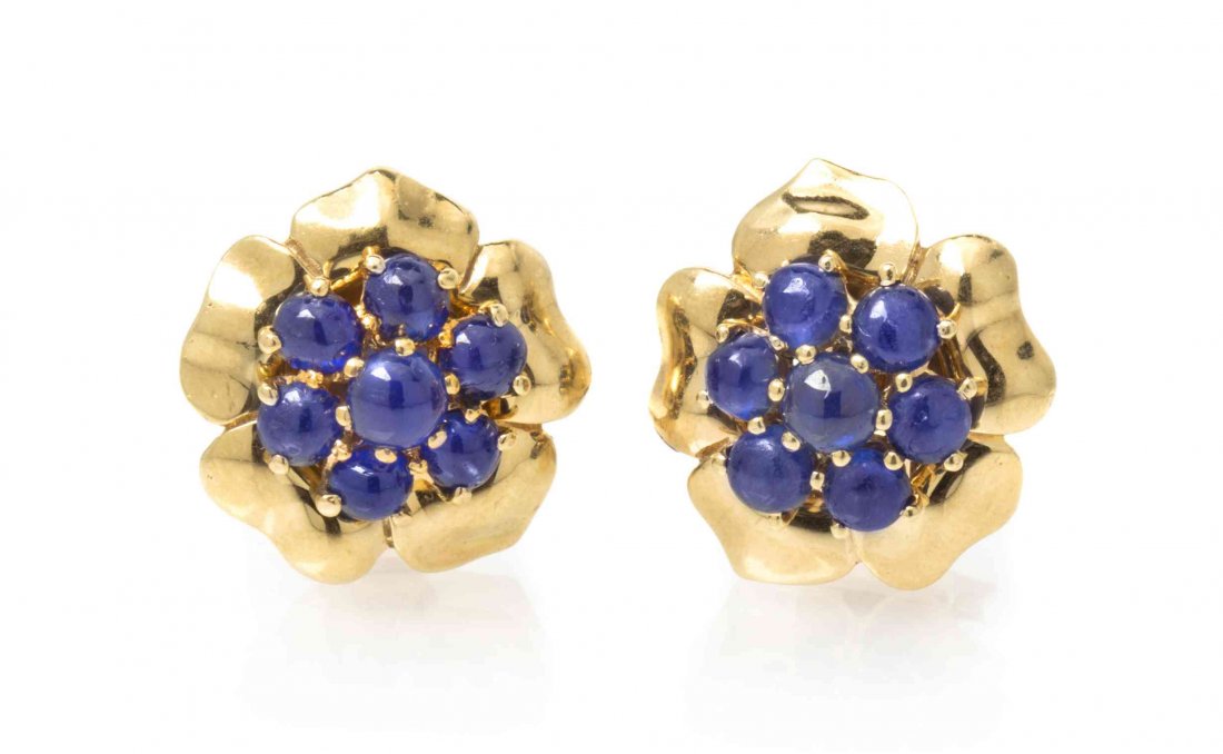 A Pair of 18 Karat Yellow Gold and Sapphire Earclips,: A Pair of 18 Karat Yellow Gold and Sapphire Earclips, Trabert & Hoeffer - Mauboussin, in a floral motif, containing 14 round cabochon cut sapphires weighing approximately 5.00 carats total. Stamp: 625