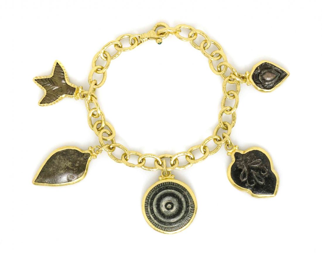 A Yellow Gold and Bronze Charm Bracelet, Gurhan, 28.40: A Yellow Gold and Bronze Charm Bracelet, Gurhan, consisting of a hammered gold cable link bracelet supporting five bronze fossil motif charms set within gold bezels, the clasp is accented with one rou