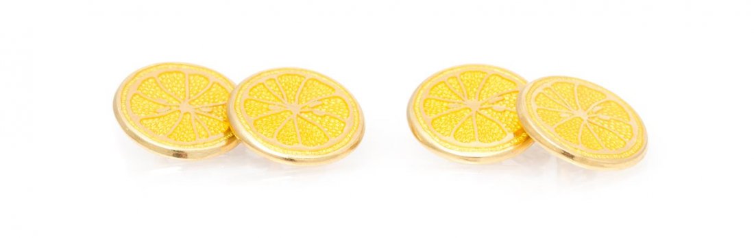 A Pair of 18 Karat Yellow Gold and Enamel Lemon Motif: A Pair of 18 Karat Yellow Gold and Enamel Lemon Motif Cufflinks, depicting lemon slices in yellow enamel over gold, circular terminals joined with cable link. Stamp: 750 (British assay marks) (maker's