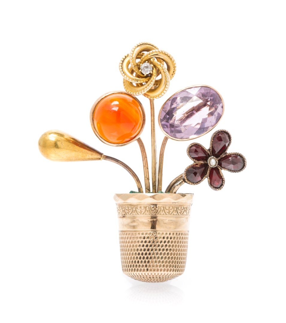 A Vintage Yellow Gold and Multi Gem Flower Pot Stick: A Vintage Yellow Gold and Multi Gem Flower Pot Stick Pin Brooch, consisting of a group of stick pins in flower motifs containing one round cabochon cut carnelian, one old mine cut diamond, one oval mi