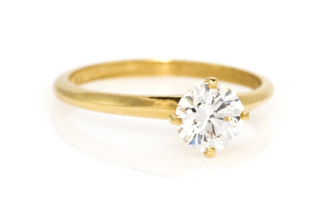 An 18 Karat Yellow Gold and Diamond Solitaire Ring,: An 18 Karat Yellow Gold and Diamond Solitaire Ring, containing one round brilliant cut diamond weighing approximately 0.70 carat. Stamp: 54912 Lebolt 18K. 1.40 dwts. Property from the Collection of Jo