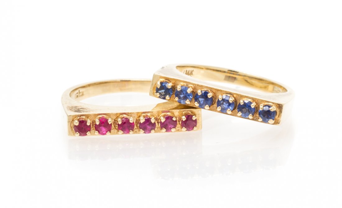 A Collection of 14 Karat Gold, Ruby and Sapphire: A Collection of 14 Karat Gold, Ruby and Sapphire Stacking Rings, consisting of one ring containing six round cut rubies measuring approximately 2.25 mm in diameter and the other ring containing six ro
