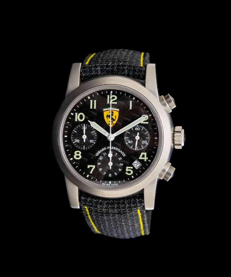 A Titanium Ref. 8020 Ferrari Edition Chronograph: A Titanium Ref. 8020 Ferrari Edition Chronograph Wristwatch, Girard Perregaux, 37.00 mm case diameter, carbon fiber dial with Ferrari logo signed GIRARD-PERREGAUX, luminous Arabic numerals, luminous s