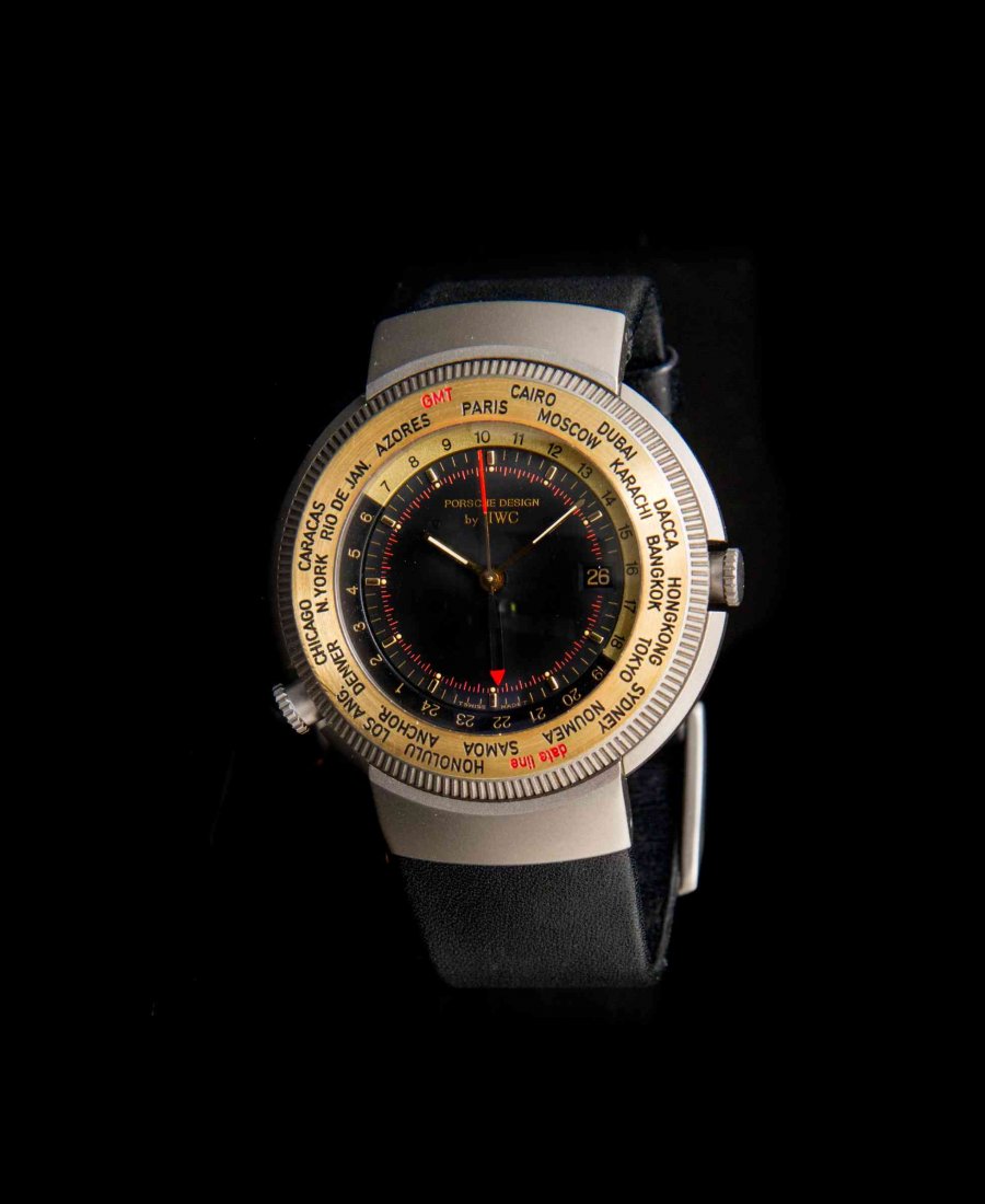 A Titanium and 18 Karat Yellow Gold Ref. 3821-003 World: A Titanium and 18 Karat Yellow Gold Ref. 3821-003 World Time Alarm Wristwatch, International Watch Co. for Porsche Design, 41.00 mm case diameter, matte black dial signed PORSCHE DESIGN by IWC, rotati