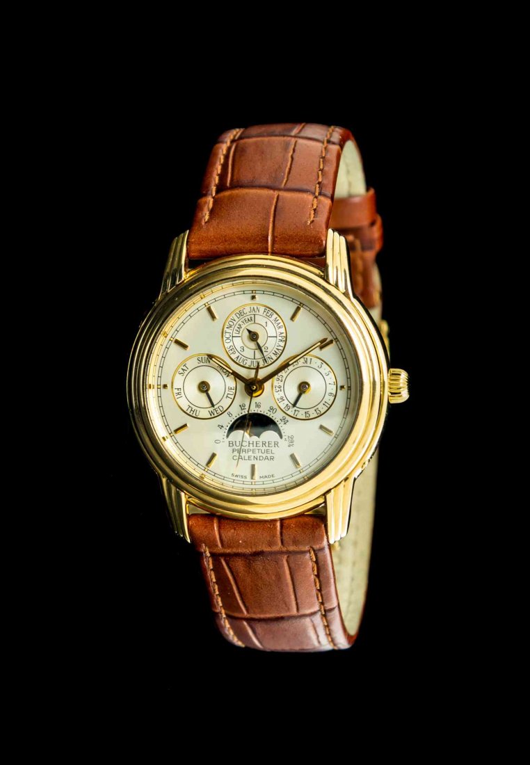 An 18 Karat Yellow Gold No. 17 Perpetual Calendar: An 18 Karat Yellow Gold No. 17 Perpetual Calendar Wristwatch, Bucherer, 35.00 mm case diameter, matte silvered dial signed BUCHERER, applied gold baton numerals, gold baton hands with center sweep sec