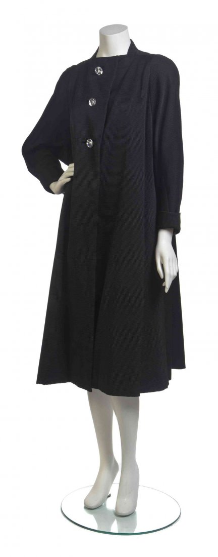 A Pauline Trigere Black Satin Ribbed Coat,: A Pauline Trigere Black Satin Ribbed Coat, cropped sleeves with a high square neckline, three faux crystal buttons and two slash pockets. Labeled: Pauline Trigere. Property from the Estate of Virginia