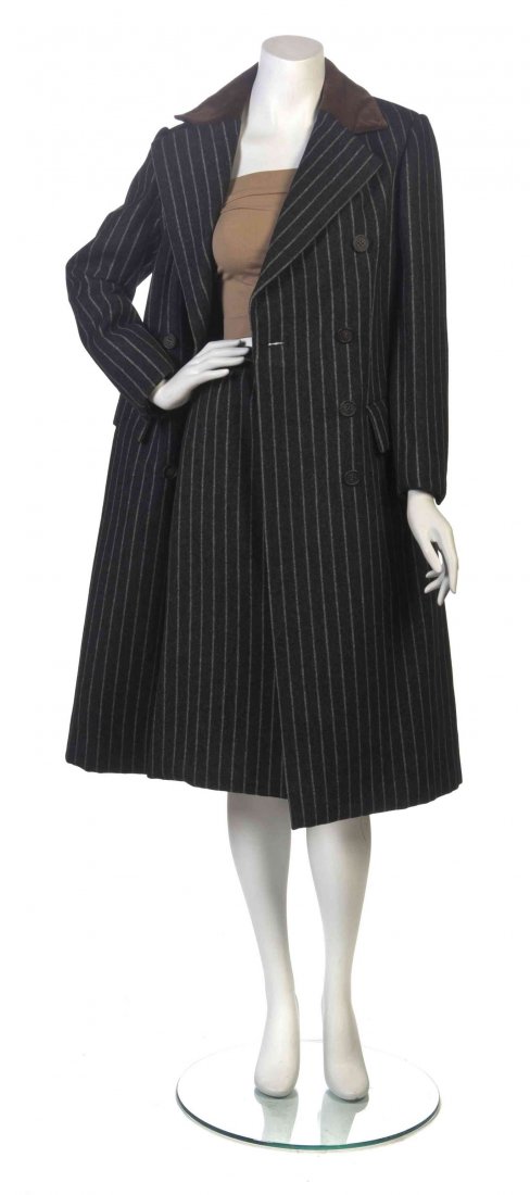 A Bill Blass Grey Wool Pinstripe Suit, Size 8.: A Bill Blass Grey Wool Pinstripe Suit, three quarter length double breasted coat with a brown suede contrast collar, together with a center front split hem skirt. Labeled: Bill Blass. Size 8.