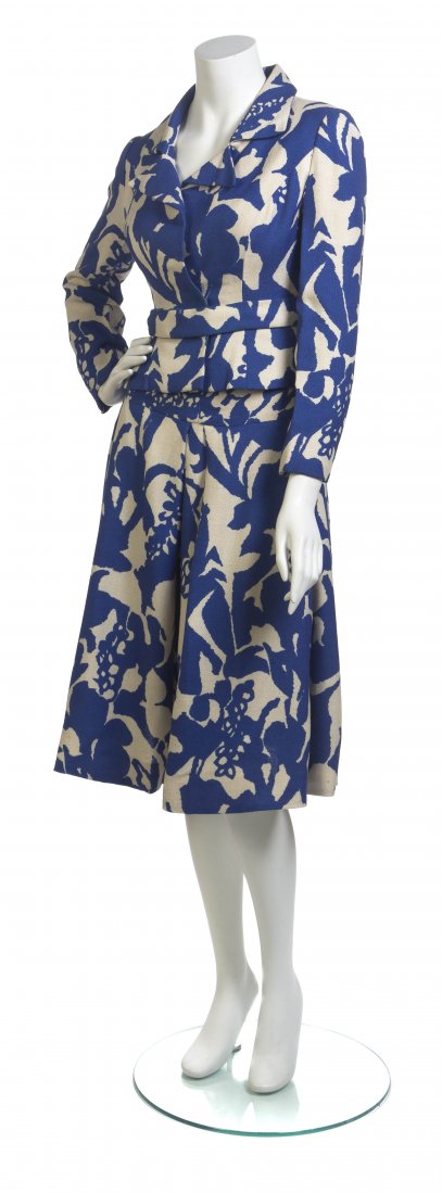 A Richard Tam Blue and Ivory Cotton Skirt Ensemble,: A Richard Tam Blue and Ivory Cotton Skirt Ensemble, jacket with a two snap button front closure and attached skinny belt, together with a front pleated skirt. Labeled: Richard Tam.