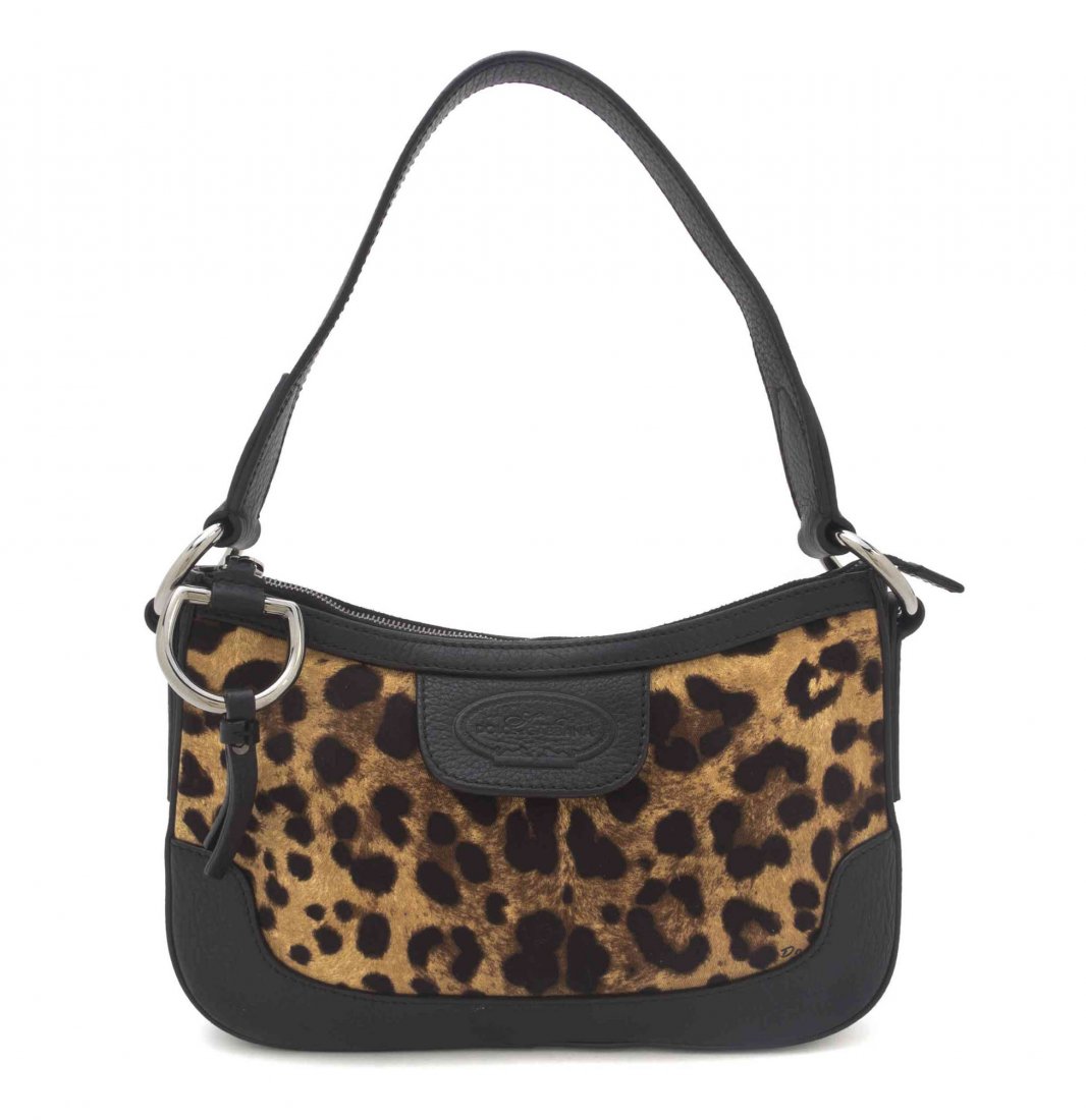 A Dolce & Gabbana Leopard Print Canvas Bag, 11 1/2 x 7: A Dolce & Gabbana Leopard Print Canvas Bag, single shoulder strap, zipper top with interior zippered pocket and leather trim. Stamped: Dolce & Gabbana. 11 1/2 x 7 x 1 inches.